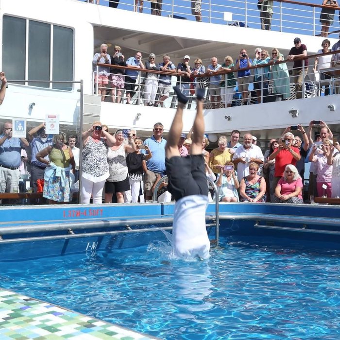 The pool deck packed with passengers during an activity
